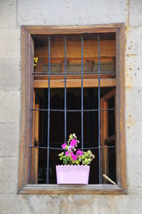 Fototapeta na wymiar Flowers in pots on the balcony next to window