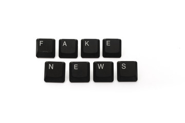 Keyboard with FAKE NEWS words conceptual of social fake news sharing.