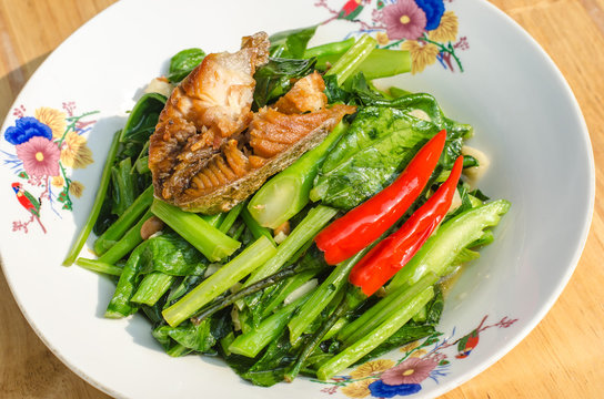 Stir fried kaled and sun dried salted fish with oyster sauce in plate, chinese broccoli and sun dried salted fish with oyster sauce in plate, Thai food, Thailand