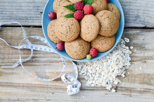 Oatmeal Cookies In A Bowl And Raspberry Next To Measuring Tape Cereal