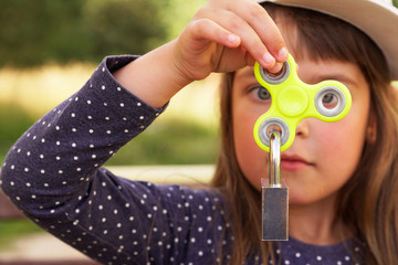 Little girl holding a spinner in her hand