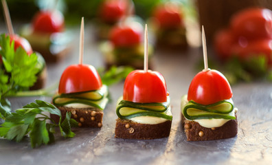 Canape with cucumber and feta cheese and cherry tomatoes. Vegetarian and vegan food
