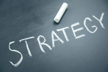 Fototapeta premium strategy text written on board with chalk