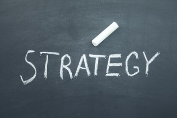 Fototapeta premium strategy text written on board with chalk