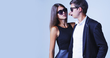 Fashion young passion couple posing dressed in classic clothes. Beautiful young man and woman, studio shot.