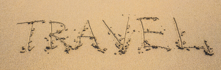 written words travel on sand of beach in summer day