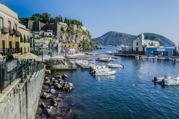 Fototapeta na wymiar Buildings surrounding the marina and old fortress on the island of Lipari