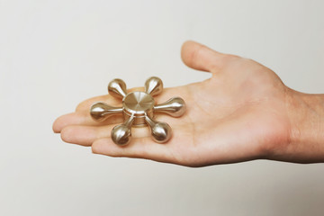 Woman's hand with spinner on neutral background