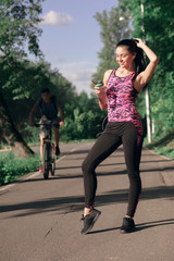 Young woman is thirsty for drinking water for recovery after running