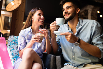Young attractive couple on date in coffee shop