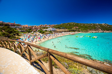 Spiaggia di Rena Bianca beach with red rocks and azure clear water,Sardinia, Italy