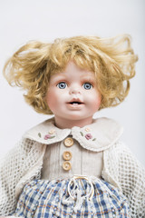 Ceramic porcelain handmade doll with big blue eyes and curly blond hair