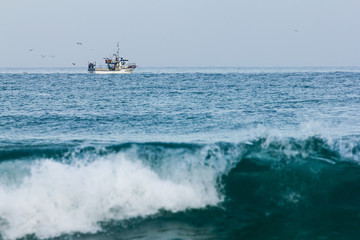 Fishermen boat out on the sea to catch some fish early in the morning.
