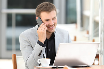 Executive attending phone call in a coffee shop