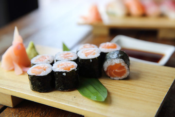 Salmon maki sushi on wood background , Japanese food