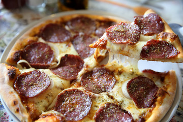 Pepperoni pizza , pizza with pepperoni mozzarella cheese and tomatoes with sauce background italian food