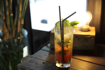 Mojito cocktail drink with mint and lemon background