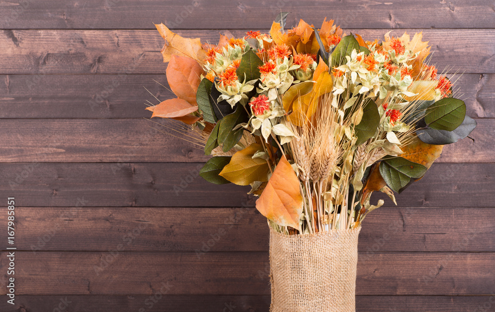 Wall mural colorful autumn bouquet on a wooden background