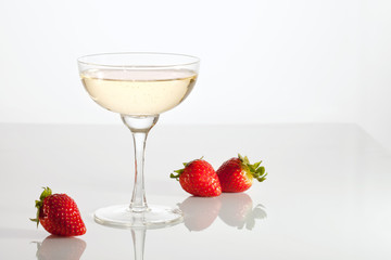 Champagne and strawberries over the glass table