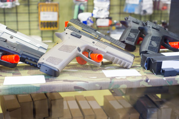 pneumatic handgun on the glass table in military shop