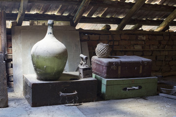 Glass, wooden and metallic objects in the attic with dust and spiderwebs in a beautiful, moody...