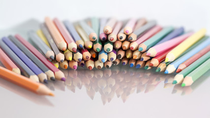 Fototapeta premium Group of sharp colored pencils with white background and reflexions 