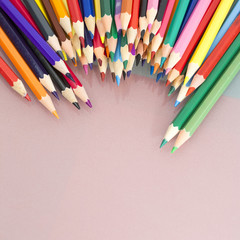 Group of sharp colored pencils with white background and reflexions
