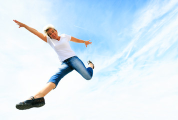 Obraz premium Woman In Her 50s Jumping High
