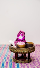 Aroma oil, facial cream, powder, towel on table, spa concept