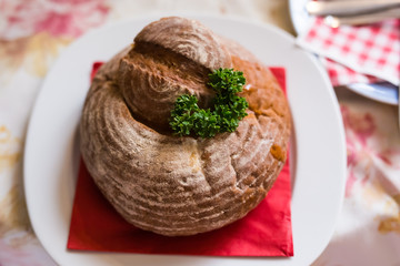 Meat soup in bread. A dish of Czech cuisine in the restaurant of Prague.