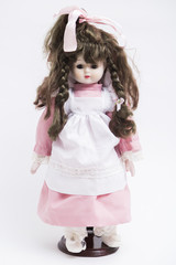 Ceramic porcelain handmade brunette doll with pigtails in pink dress