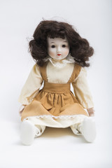 Ceramic porcelain handmade doll with long brunette hair and beige dress
