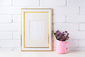 Gold decorated frame mockup with purple flowers in pink rustic pitcher