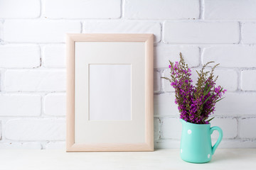 Wooden frame mockup with maroon purple flowers in mint pitcher