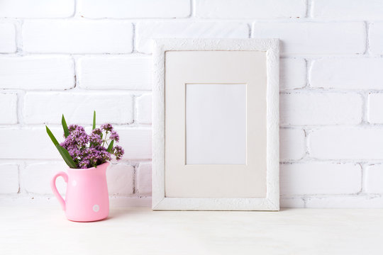 White frame mockup with purple flowers in pink rustic pitcher