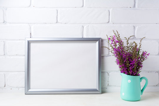 Silver landscape frame mockup with maroon purple flowers in mint pitcher