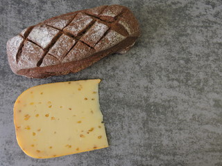 Rye bread and cheese on a gray background, top view 