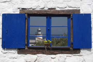 Fototapeta na wymiar Scario's lighthouse at the window