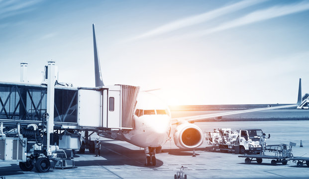 Airport With Many Airplanes At Beautiful Sunset