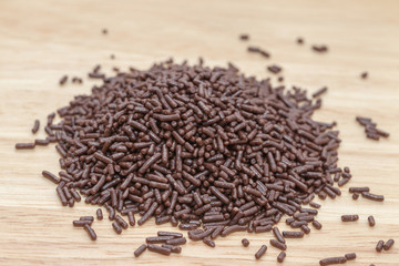 chocolate sprinkles on wooden plate