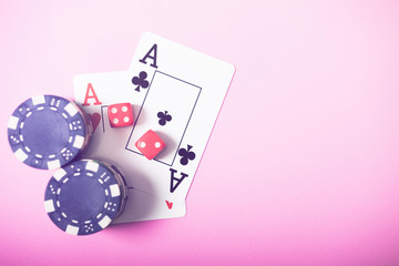 Gambling chips and cards on a green cloth Casino table