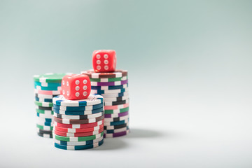 Gambling chips and cards on a green cloth Casino table