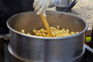 Making popcorn in the small kiosk. Heat, butter and salt