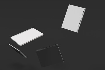 Four notebooks with spiral bound on black background