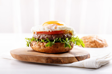 Close-up of beef burger on white background.