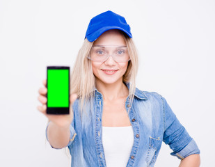 Woman holding smart phone with green screen