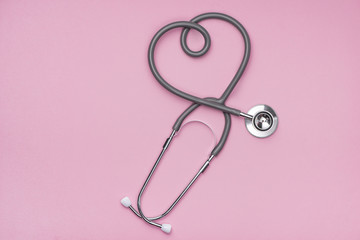 Medical concept. The stethoscope with heart shape on pink background. - obrazy, fototapety, plakaty