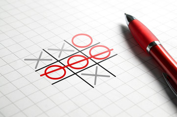 Tic tac toe game. Noughts and crosses. Paper and pen. Winning and success concept.
