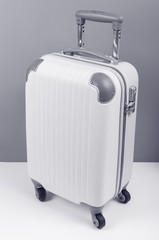 travel luggage or suitcase on plain background, monotone filter effect