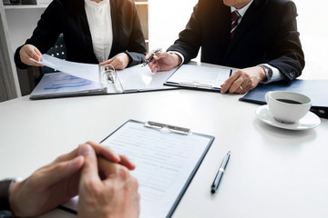 Businessman conducting an interview with businessman in an office